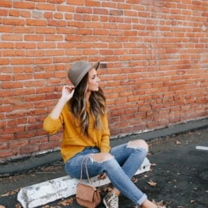 mustard yellow sweater and leopard sneakers