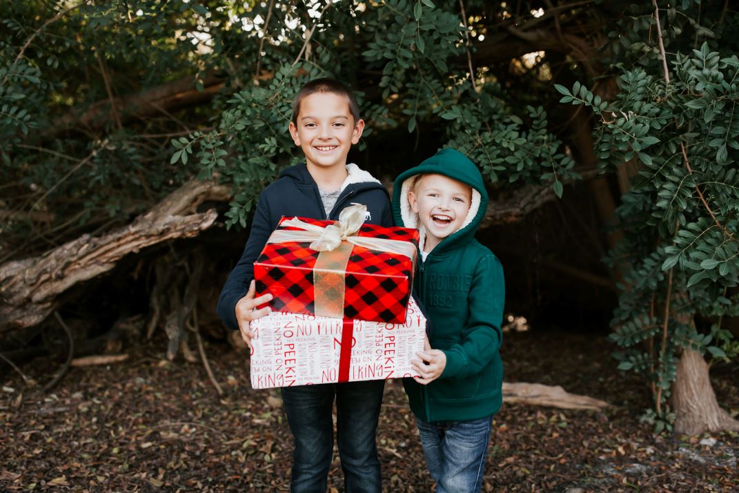boys holding christmas presents wrapped