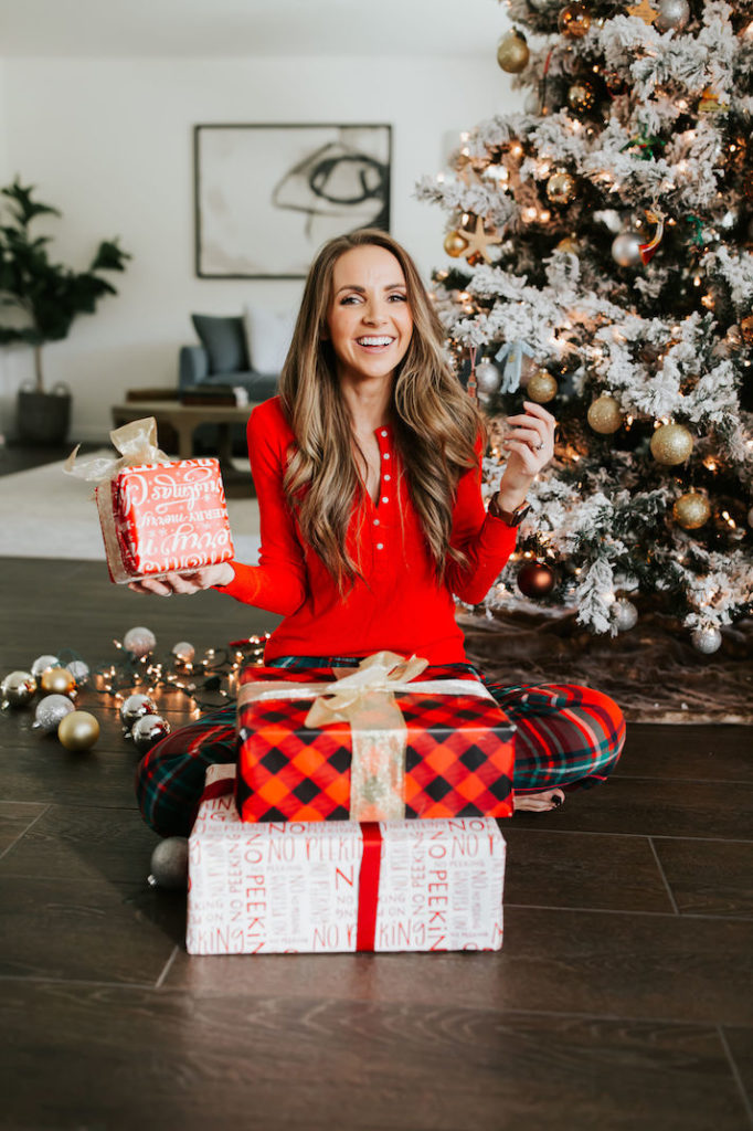 merrick in front of the tree with gifts