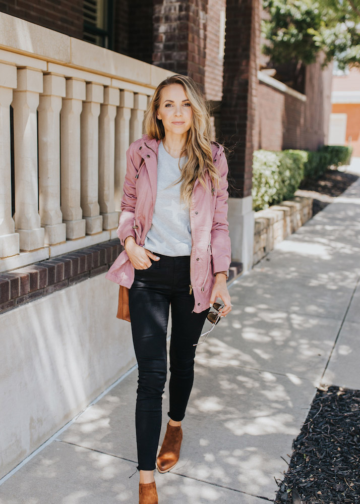pink anorak jacket and black jeans