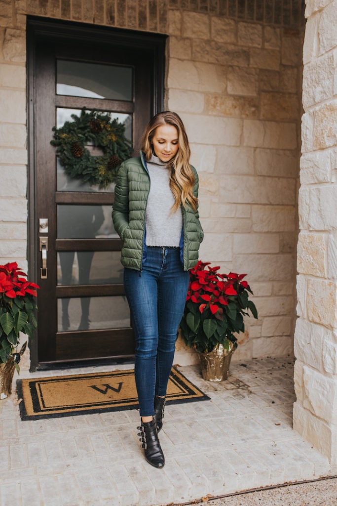 merrick on front porch with poinsettas in green puffer jacket