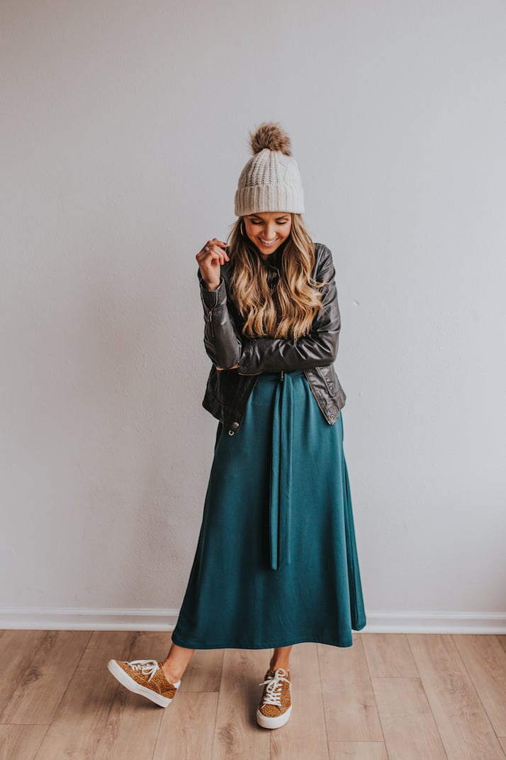 dress with leather jacket, beanie, and sneakers