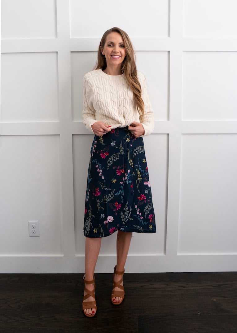 wearing a sweater over a dress
