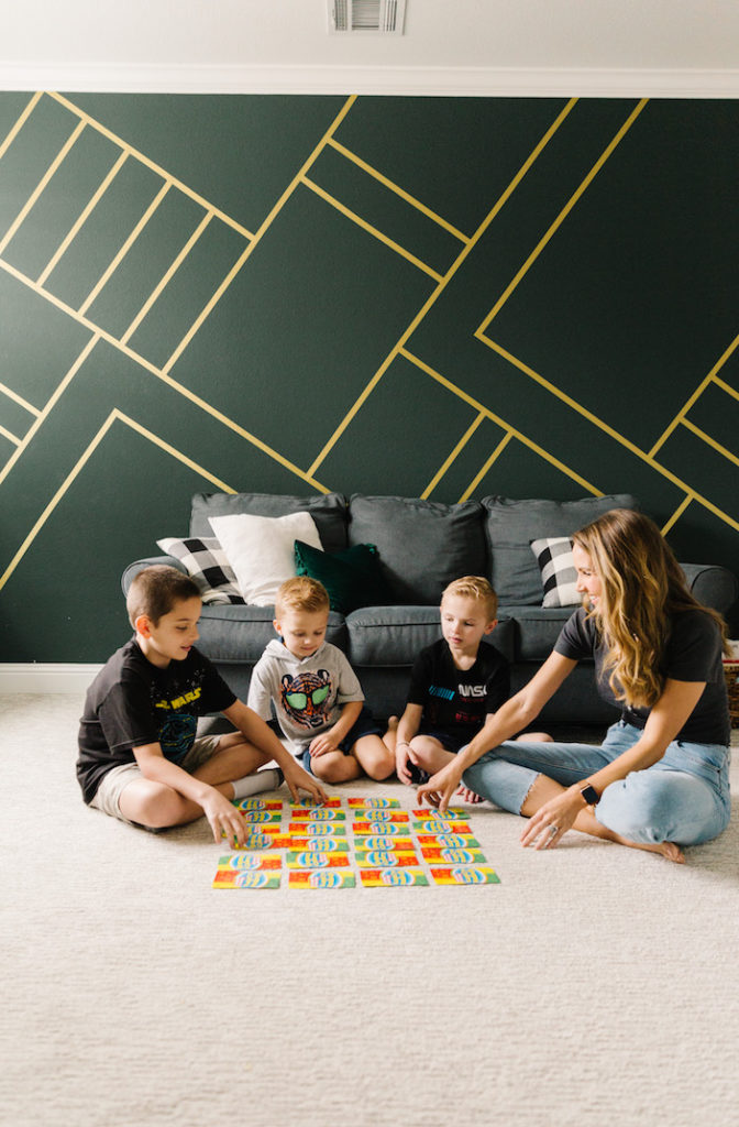 green wall with gold wallpaper stripes